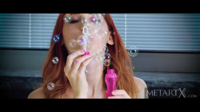 Redhead watches porn and fools around alone