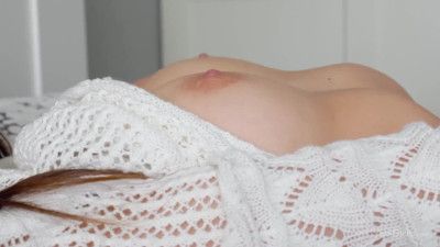 Enticing lassie tenderly rubs pussy solo on the bed