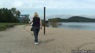 Outdoors screwing for a busty GILF by a young blond man