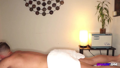 Inked brunette Riley massages a client and jerks his dick