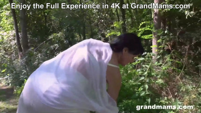 Older woman masturbates and fucks in the forest