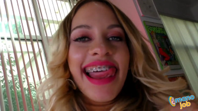 Blonde woman with braces is having fun with a big one